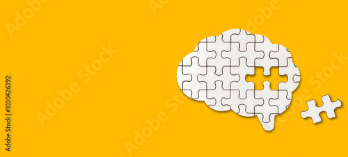 Brain shaped white jigsaw puzzle on yellow background. A missing piece of the brain puzzle. Mental health and problems with memory.