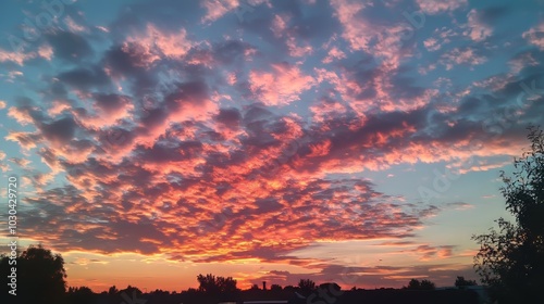 The sky is a beautiful mix of colors at sunset, with fluffy clouds. This would be a great picture for nature or abstract photography.