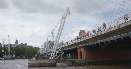 Pedestrian Bridge Over River Thames in London photo