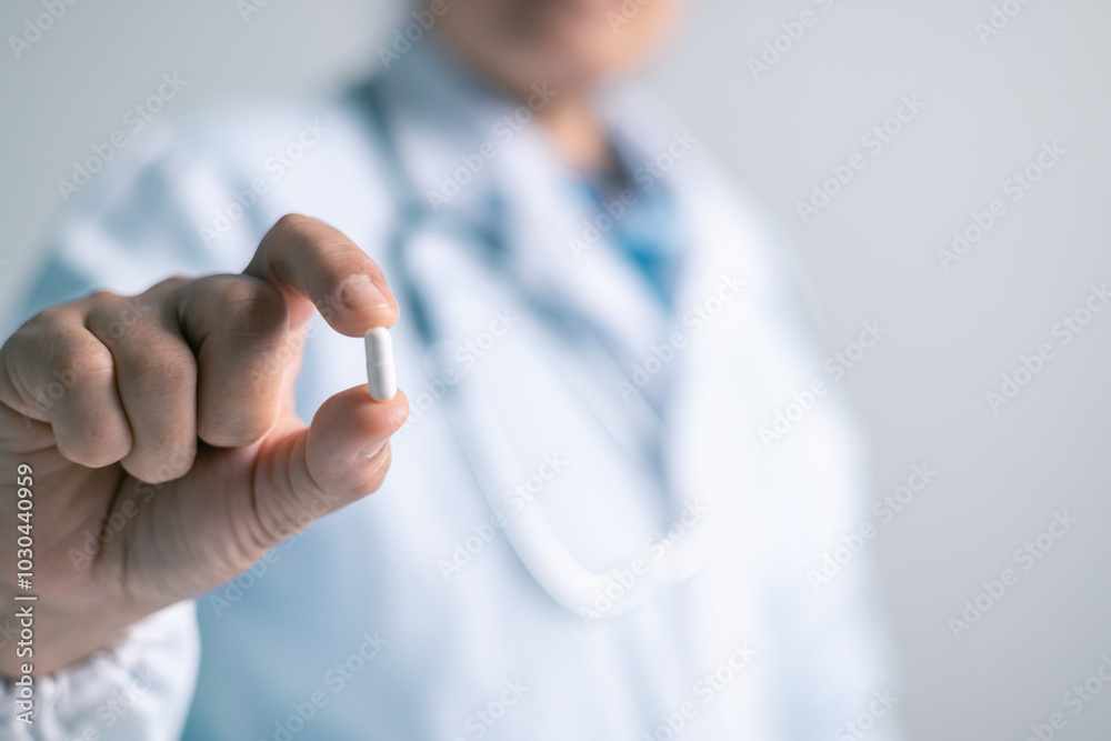 Doctor office, woman held medical capsule in her hand, illustrating role of medicine and pills in health care and overall health. woman, office, doctor, health, medical, capsule, pill, medicine. Doctor office, woman held medical capsule in her hand, illustrating role of medicine and pills in health care and overall health. woman, office, doctor, health, medical, capsule, pill, medicine.