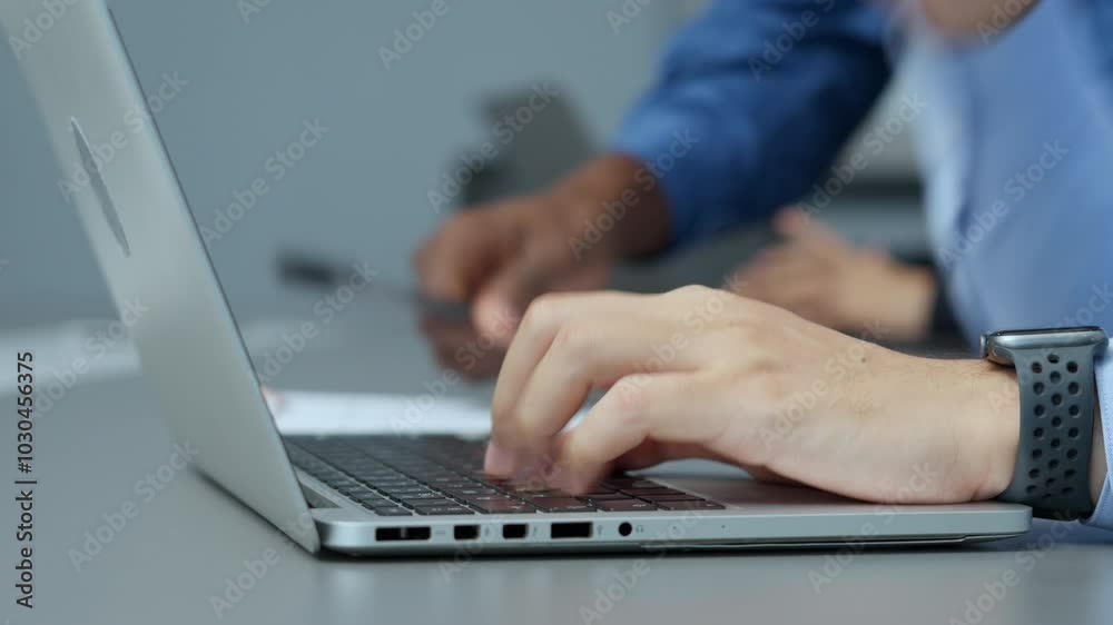 Close-up of hands typing on a laptop in an office setting, focusing on productivity and technology during a professional task. Close-up of hands typing on a laptop in an office setting, focusing on productivity and technology during a professional task.