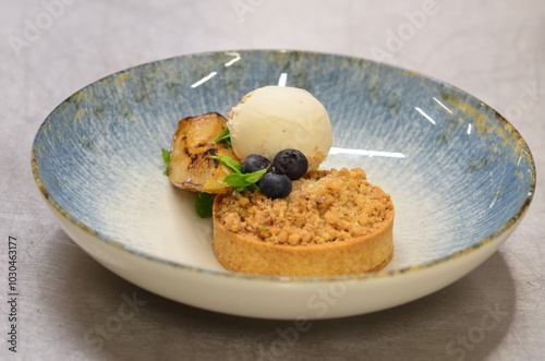 Fototapeta Naklejka Na Ścianę i Meble -  delicious dessert with fruits, pear pie, crumble, ice cream, served dessert in a restaurant, food background