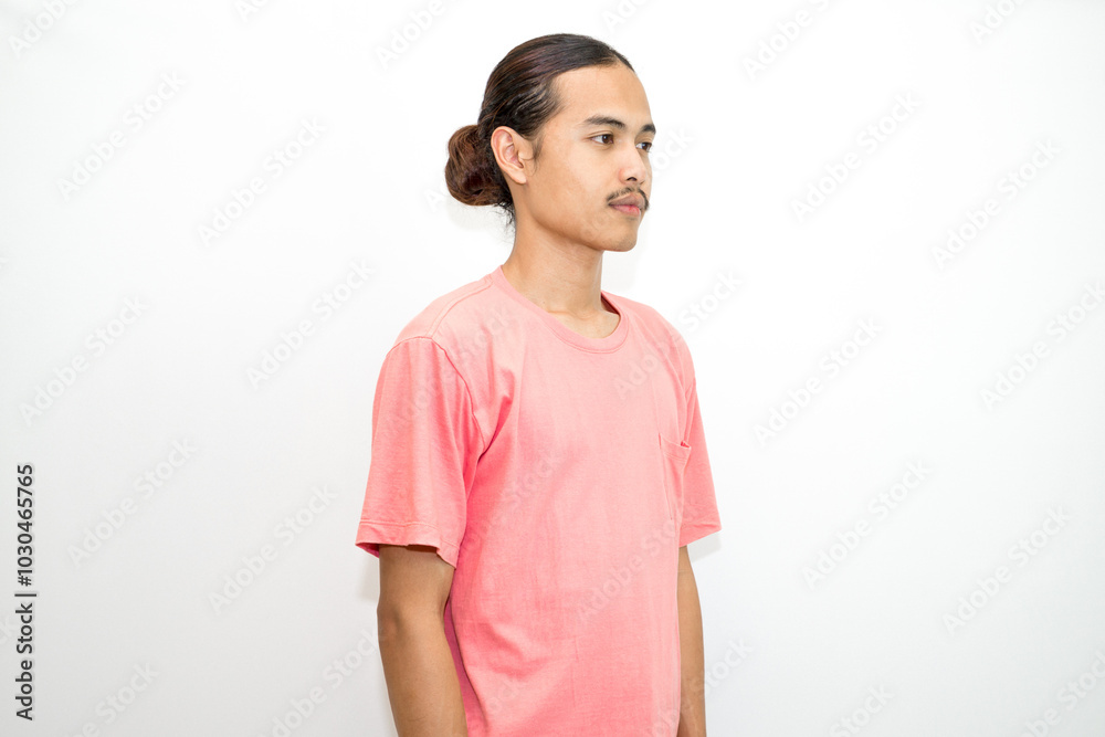 An Indonesian, Asian man wearing a pink tshirt formal style involving his partner with standing confidence like a mature person and a young businessman. isolated in white background An Indonesian, Asian man wearing a pink tshirt formal style involving his partner with standing confidence like a mature person and a young businessman. isolated in white background
