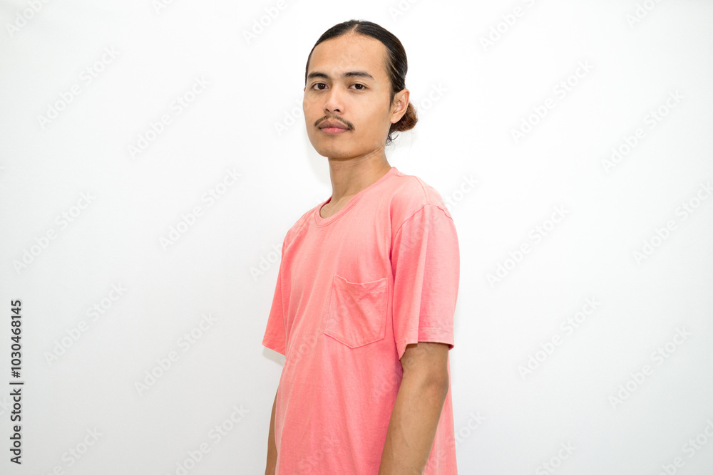 An Indonesian, Asian man wearing a pink tshirt formal style involving his partner with standing confidence like a mature person and a young businessman. isolated in white background An Indonesian, Asian man wearing a pink tshirt formal style involving his partner with standing confidence like a mature person and a young businessman. isolated in white background