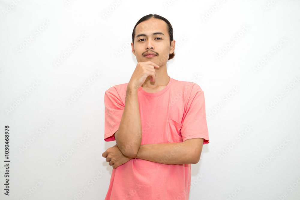 An Indonesian, Asian man wearing a pink tshirt formal style involving his partner with standing confidence like a mature person and a young businessman. isolated in white background An Indonesian, Asian man wearing a pink tshirt formal style involving his partner with standing confidence like a mature person and a young businessman. isolated in white background