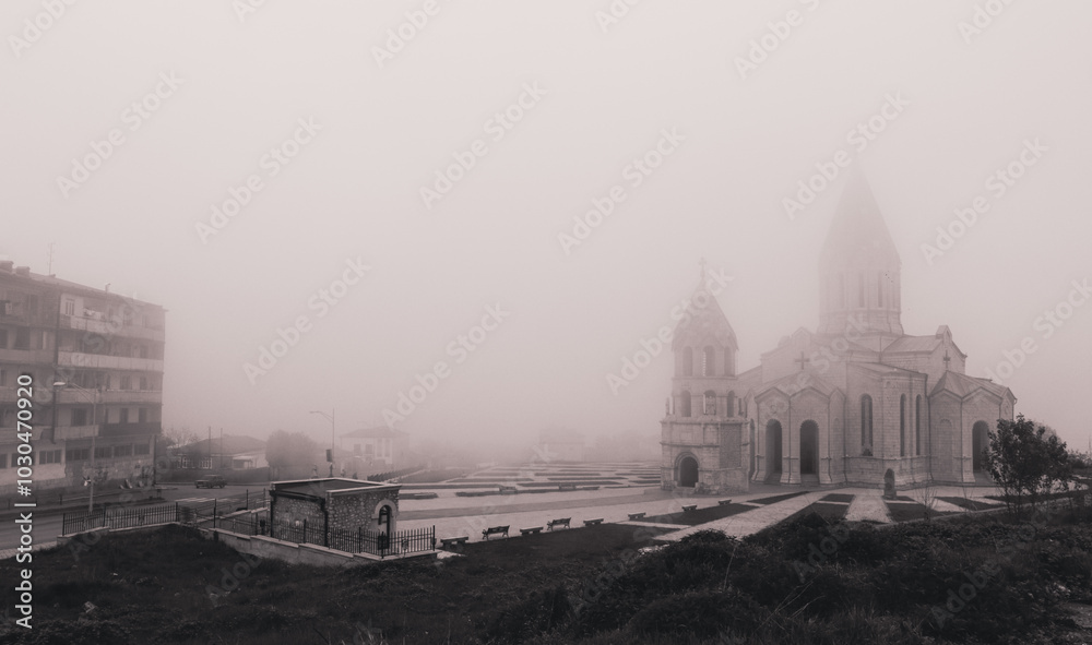 Fototapeta premium Fog envelops the historic architecture of Nagorno Karabakh during a quiet morning, lending an air of mystery to the landscape