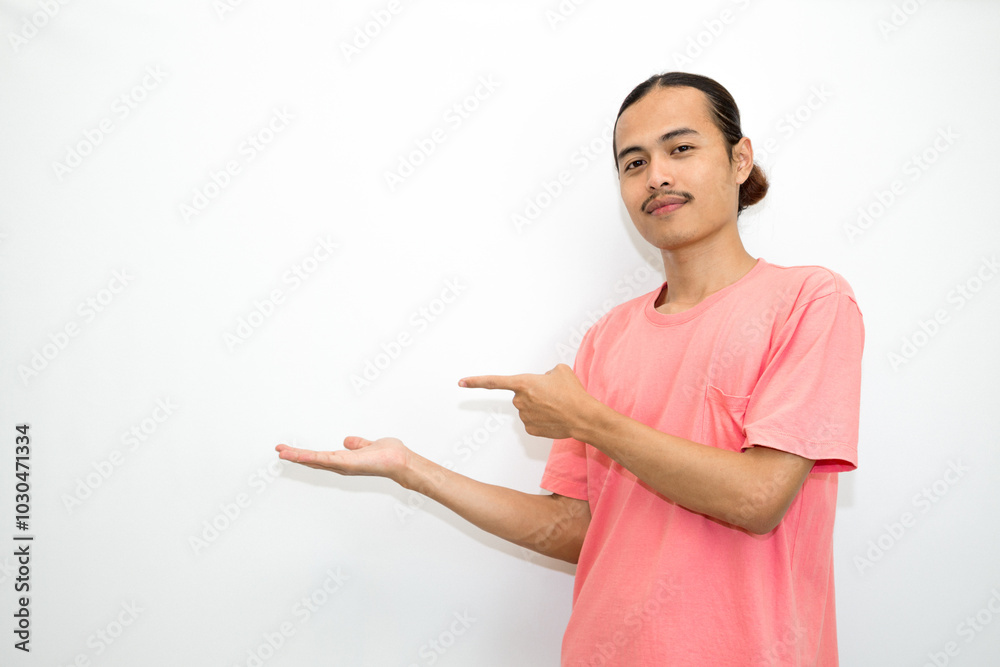 Asian, Indonesian man standing wearing pink shirt pointing right, left, up, down and presenting using hand gestures. Isolated on white background Asian, Indonesian man standing wearing pink shirt pointing right, left, up, down and presenting using hand gestures. Isolated on white background
