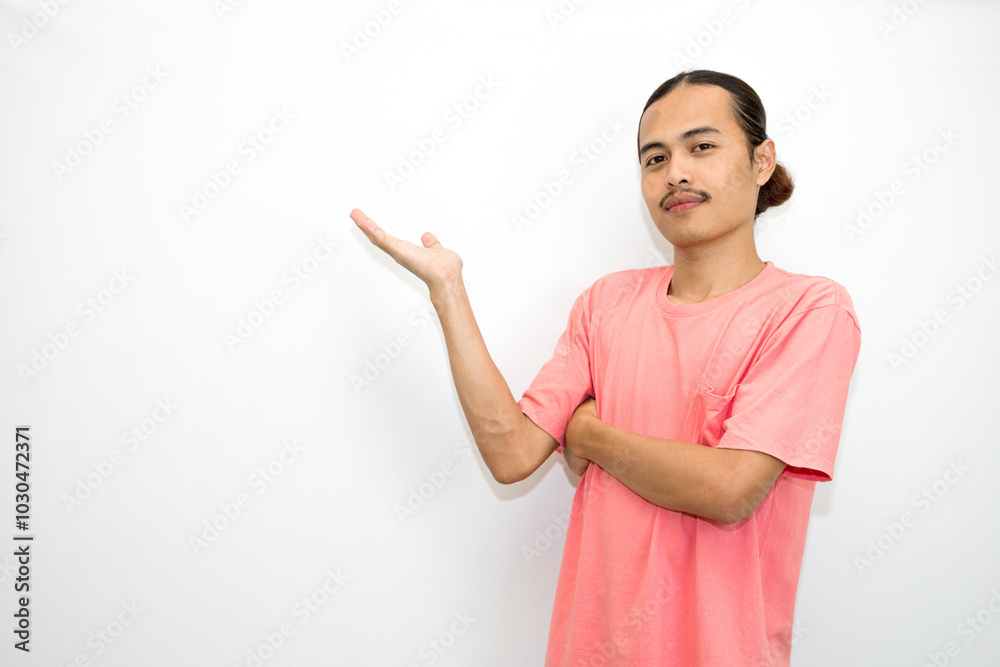 Asian, Indonesian man standing wearing pink shirt pointing right, left, up, down and presenting using hand gestures. Isolated on white background Asian, Indonesian man standing wearing pink shirt pointing right, left, up, down and presenting using hand gestures. Isolated on white background