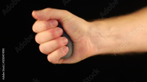 Hand grip exercise demonstrating strength training techniques indoors