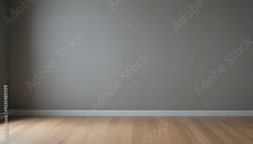 An empty room with a gray wall and a wooden floor.