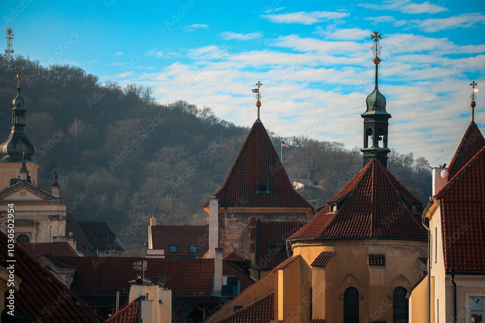 Exploring the charming rooftops and historical architecture of Prague against a backdrop of clear blue skies Exploring the charming rooftops and historical architecture of Prague against a backdrop of clear blue skies