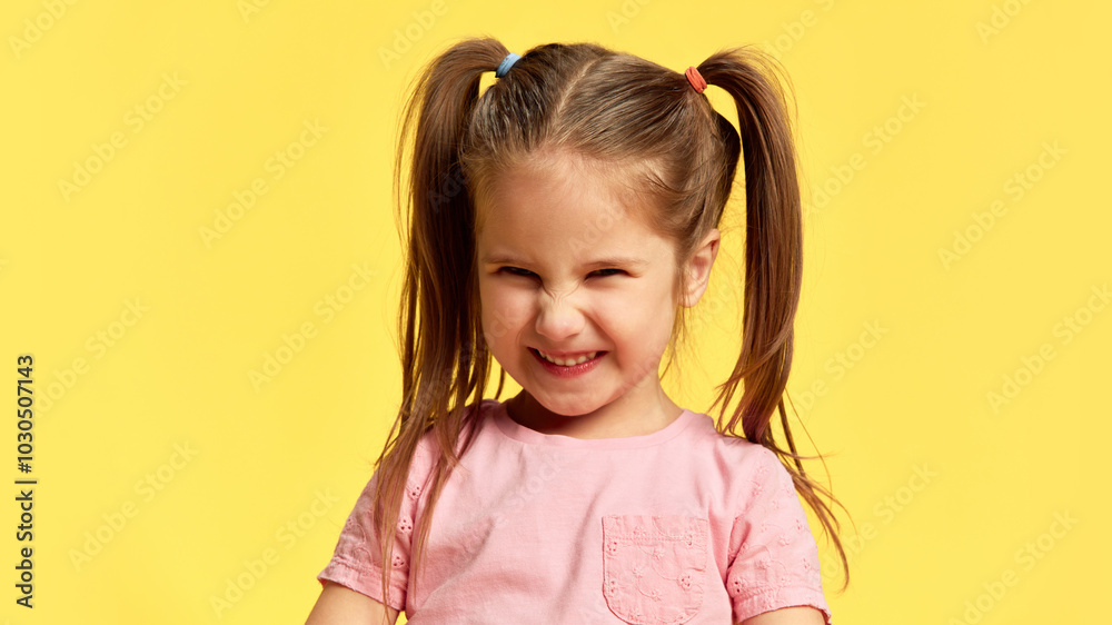 Portrait of girl closes her eyes, smiling with scrunched-up face in pure joy against sunny yellow background. Concept of facial-expressions, positive and negative emotions. Ad Portrait of girl closes her eyes, smiling with scrunched-up face in pure joy against sunny yellow background. Concept of facial-expressions, positive and negative emotions. Ad