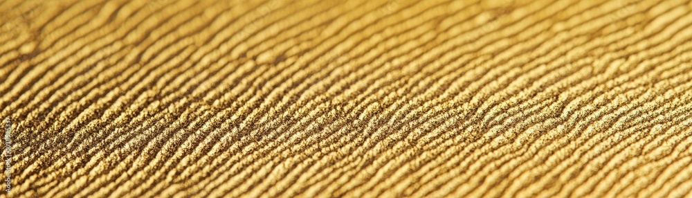 Close-up of golden textured sand with fine ripples Close-up of golden textured sand with fine ripples