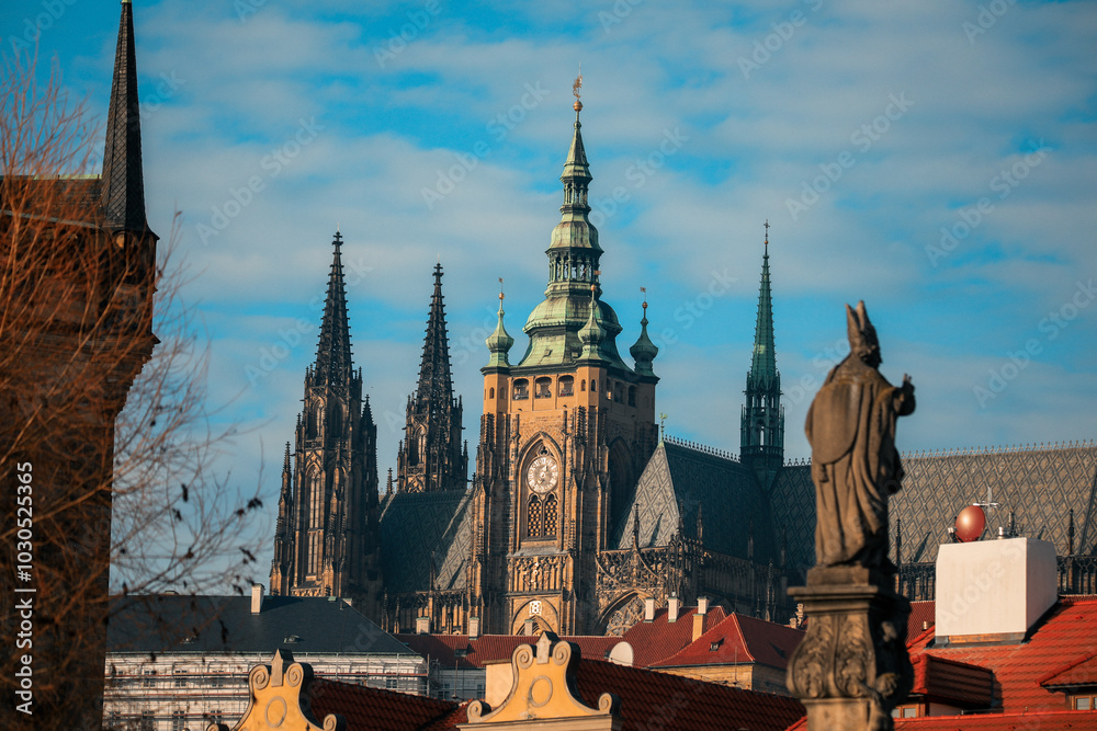 Obraz premium View of Prague Castle with Gothic spires under a bright blue sky during the day in the historic city of Prague Czech Republic