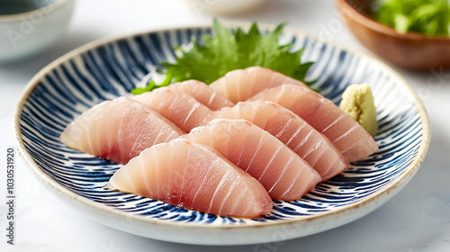 Fresh yellowtail sashimi on a traditional Japanese plate