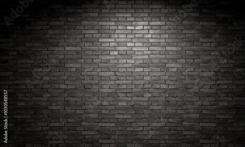 Fototapeta Naklejka Na Ścianę i Meble -  Spotlight shining on a black brick wall background