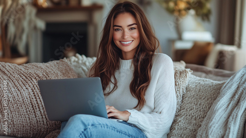 A Smiling Woman in Her Late Thirties Working from Home on a Laptop, Surrounded by a Living Room Decorated with Colorful Pillows and a Touch of Nature