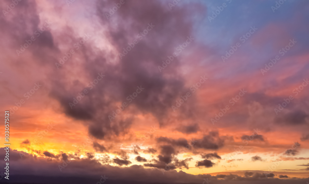 A beautiful sky tinted by the sun leaving vibrant shades of gold, pink, blue and multicolored. Clouds in the twilight evening and morning sky. Cloudy sky background in the evening, and during the day. A beautiful sky tinted by the sun leaving vibrant shades of gold, pink, blue and multicolored. Clouds in the twilight evening and morning sky. Cloudy sky background in the evening, and during the day.
