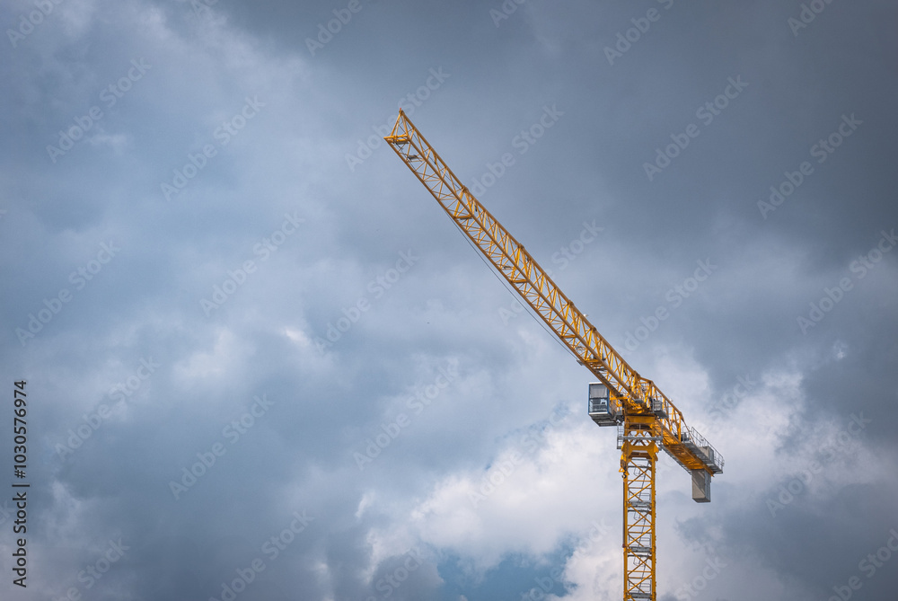 grey cloudy sky background and yellow tower crane grey cloudy sky background and yellow tower crane