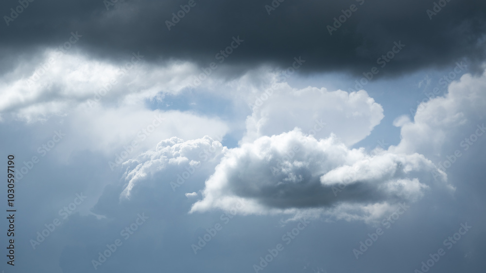 Small bright cloud under dark cloud, isolated Small bright cloud under dark cloud, isolated