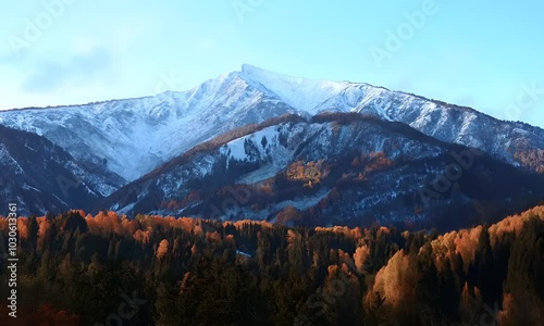 A mountain in the USA in autumn, with scenic snow-covered mountains in the background, tourists travel to enjoy nature and life concepts.