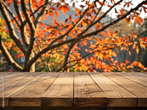 Obraz na płótnie Empty wood table top and blurred autumn tree and red leaf background w salonie