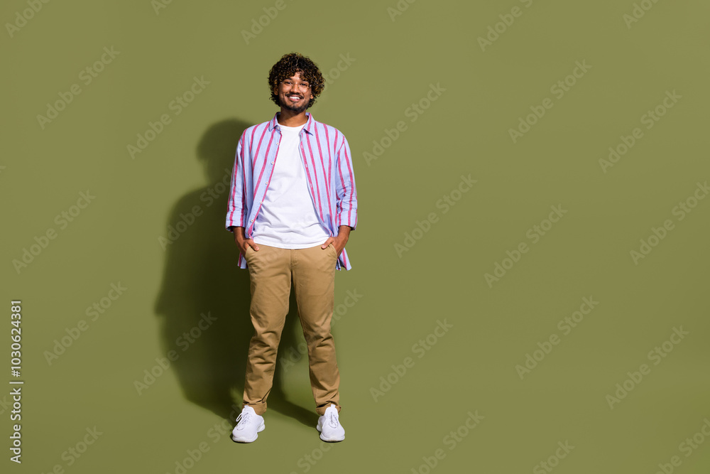 Portrait photo of candid arab businessman in trendy casual shirt and eyeglass posing confident isolated on khaki color background Portrait photo of candid arab businessman in trendy casual shirt and eyeglass posing confident isolated on khaki color background