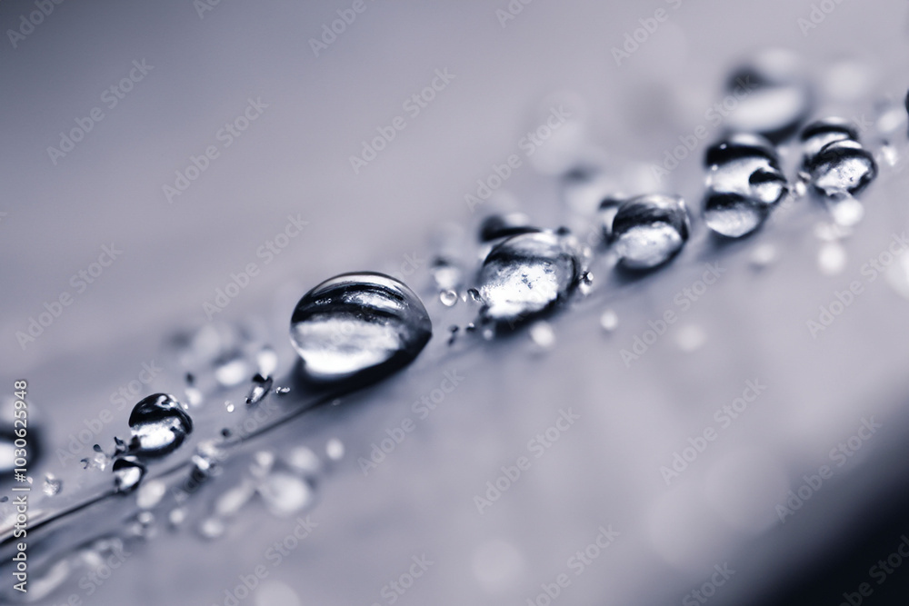 Macro shot of water droplets on metallic surface Macro shot of water droplets on metallic surface