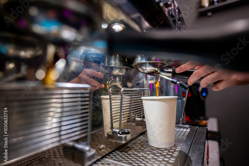 Wallpaper Mural Skilled barista operating an espresso machine, filling a white cup with fresh coffee in a cozy café ambiance Torontodigital.ca
