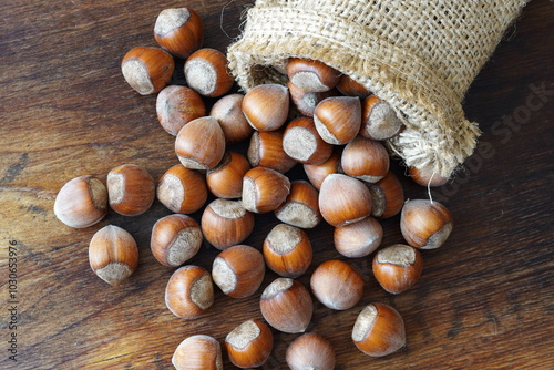 Hazelnuts in linen sack on wooden table