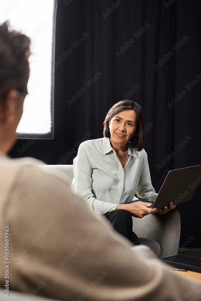 A middle-aged journalist engages in an insightful interview with a male specialist in a warm atmosphere. A middle-aged journalist engages in an insightful interview with a male specialist in a warm atmosphere.