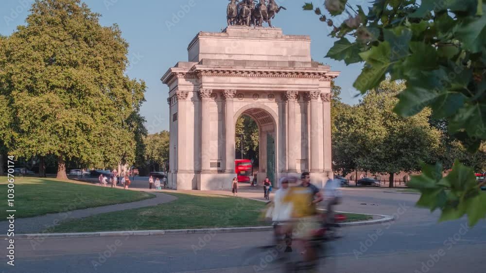 Time-lapse of Wellington Arch with people walking and commuting on a sunny day in London, UK Time-lapse of Wellington Arch with people walking and commuting on a sunny day in London, UK