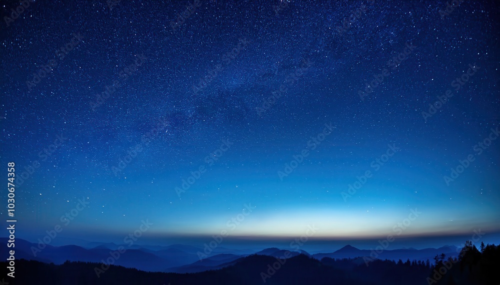 Fototapeta premium Expansive Night Sky Over Mountainous Horizon with Thousands of Stars Illuminating the Deep Blue Twilight, Capturing the Serene Transition from Dusk to Dawn in a Vast and Tranquil Wilderness