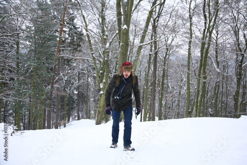 Young man in winter forest