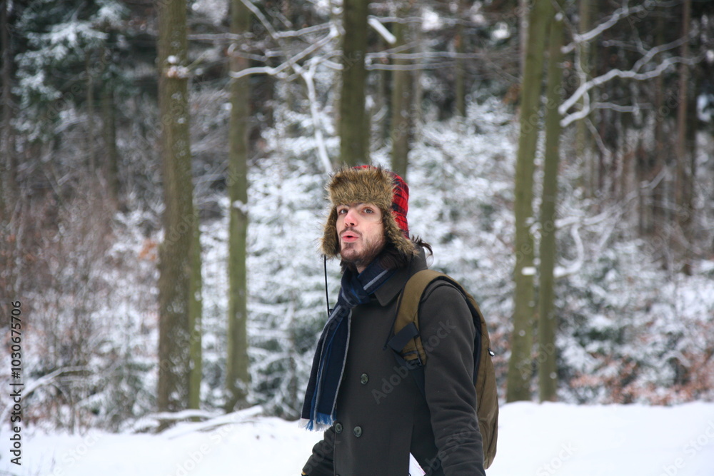 Young man in winter forest Young man in winter forest