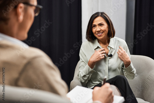 A journalist interviews a specialist as they discuss key insights in a professional atmosphere.