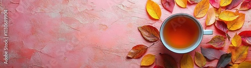 autumn banner with a cup of tea and colorful autumn leaves on a muted color background. composition for a autumn banner.