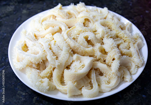 Beef tripe (bucho), beef stomach, tripe on a white plate. Dobradinha photo