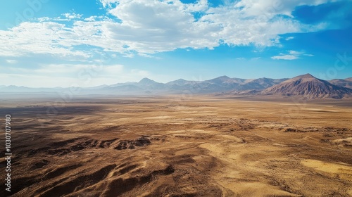 Aerial view of the Atacama Desert with barren, sunlit plains and large open sky for copy
