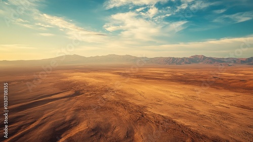 Aerial view of the Atacama Desert with barren, sunlit plains and large open sky for copy