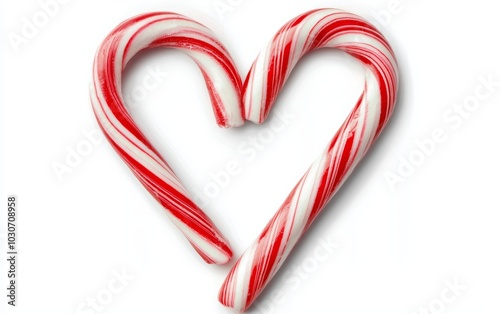 A candy cane heart formed by two candy canes, their stripes perfectly aligned, isolated on a white background photo