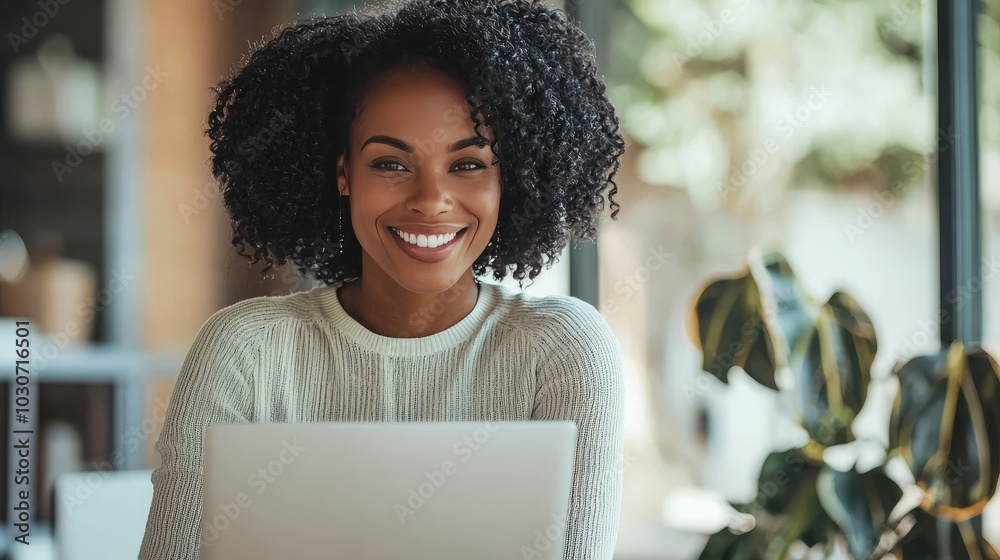 Business woman smiling while working on a laptop. S Business woman smiling while working on a laptop. S