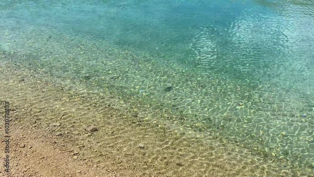The movement of clear blue water with light ripples. The movement of clear blue water with light ripples.