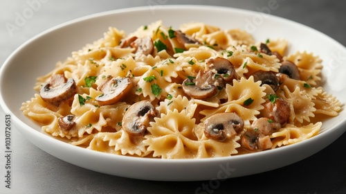 A plate of bowtie pasta with mushrooms and a creamy sauce, garnished with parsley.