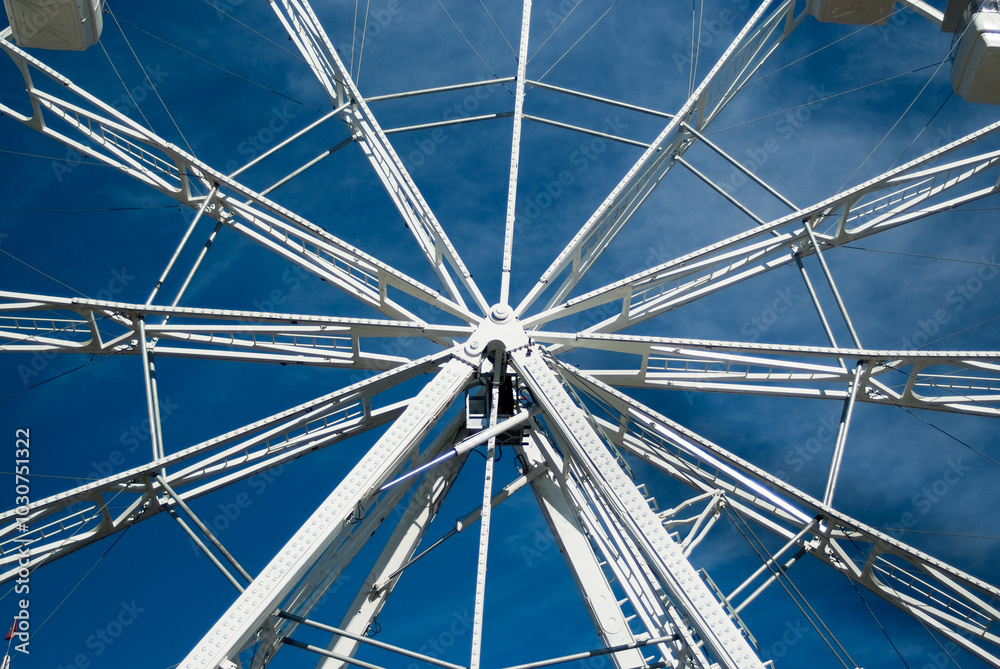 white ferris wheel against blue sky and clouds white ferris wheel against blue sky and clouds