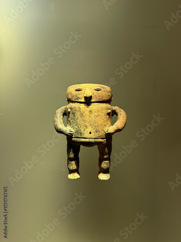 A pre-Hispanic Colombian figure depicts a slender, elongated human form, intricately adorned. Crafted from clay, it showcases cultural symbolism, reflecting spirituality and ancestral heritage.