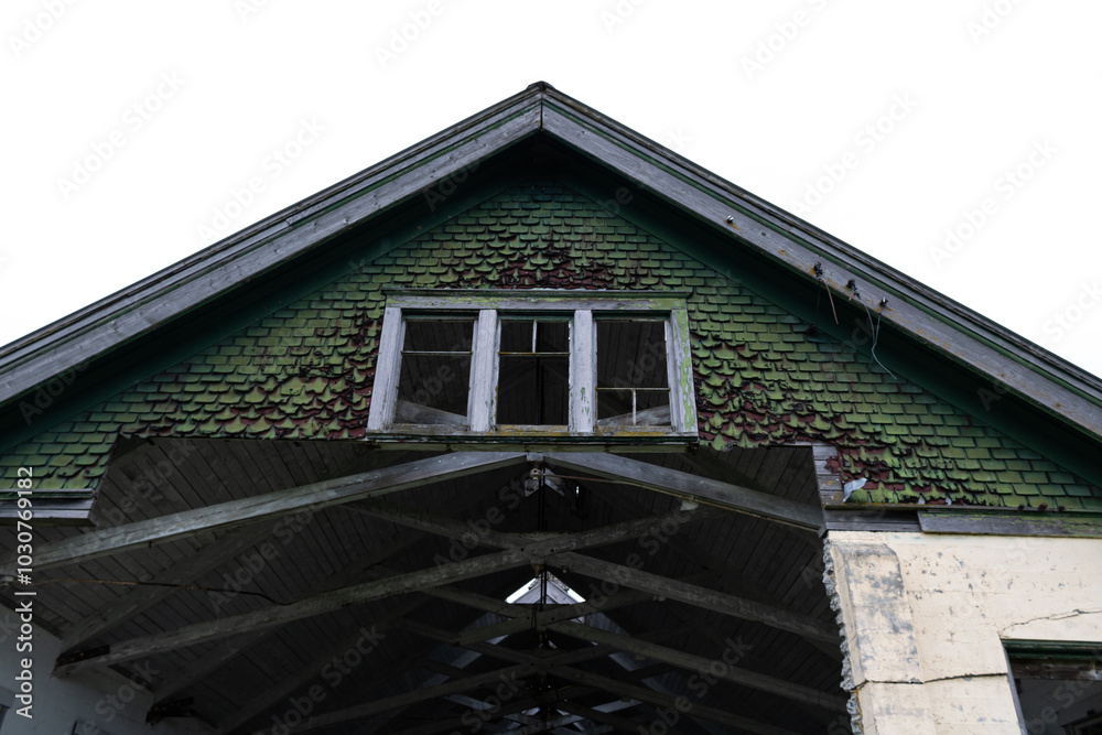 Abandoned building with an upper chunk missing, showing the interior cut out below a decaying window with broken panes and moss growth. Abandoned building with an upper chunk missing, showing the interior cut out below a decaying window with broken panes and moss growth.