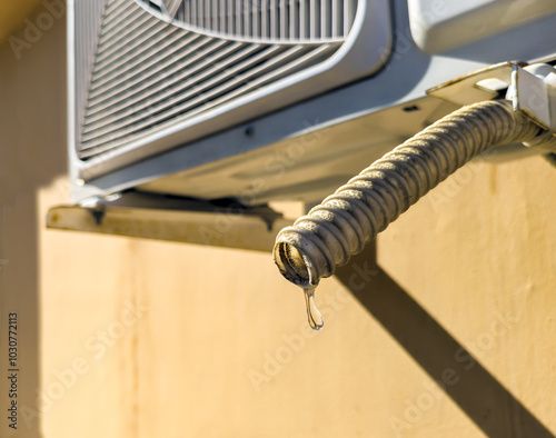 Condensation dripping from air conditioner drain pipe