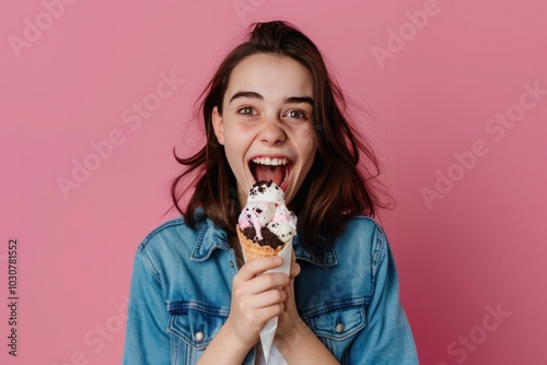 Excited brunette youngster with wavy hair indulging in a cookies and cream ice cream cone