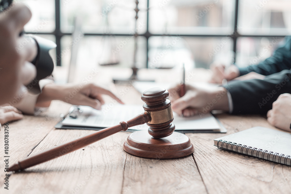 Male lawyer working with contract documents and wooden hammer on table in courtroom justice and law Judge in suit or lawyer working with documents Law, advice, close-up pictures Male lawyer working with contract documents and wooden hammer on table in courtroom justice and law Judge in suit or lawyer working with documents Law, advice, close-up pictures